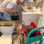 a man servicing the bathroom